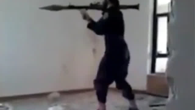 Daesh insurgent fires an RPG inside a room Daesh insurgent fires an RPG inside a room