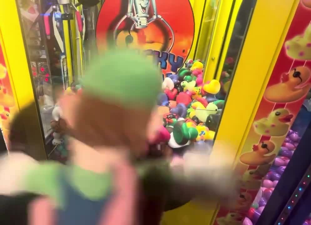 Luigi plays a rubber Ducky claw machine ￼